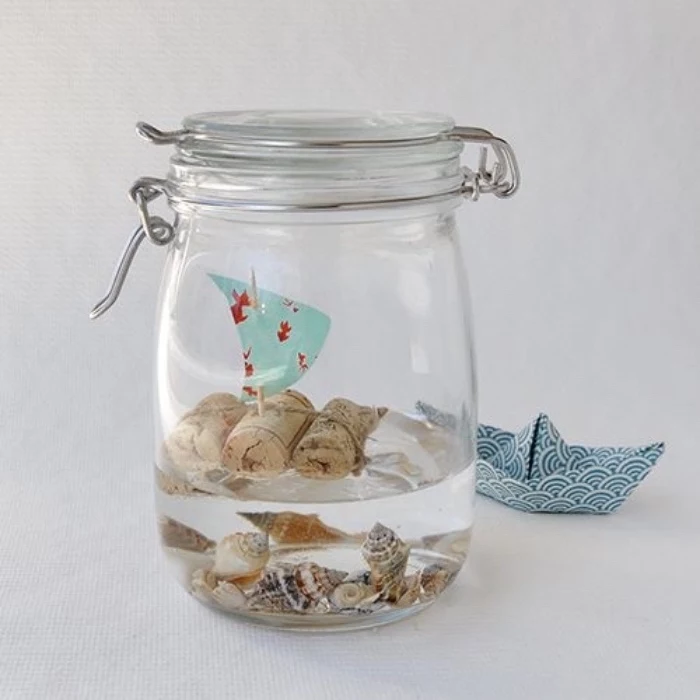 mason jar, filled with water and seashells, creative things to do when bored, small boat, made from corks