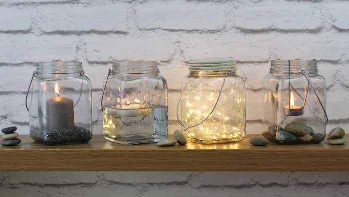 large glass jars, candles inside, fairy lights, diys for your room, wooden shelf, white brick wall