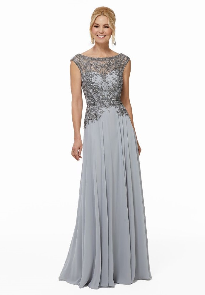 grey chiffon, lace top, navy blue mother of the bride dress, blonde hair, in a low updo, white background