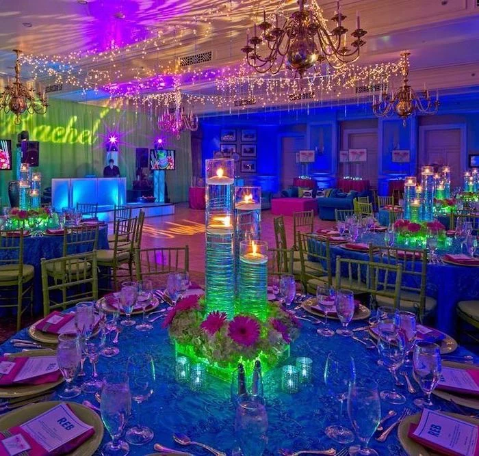 teen birthday party ideas, neon decor, tall candlesticks, neon flower bouquets, large chandelier