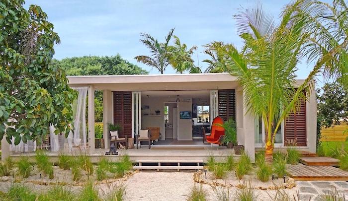 palm trees, beach house, orange wooden swing, outdoor covered patio, garden furniture