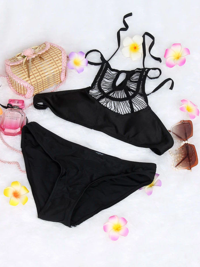 black two piece, big girl bathing suits, faux flowers, perfume and bag, white background
