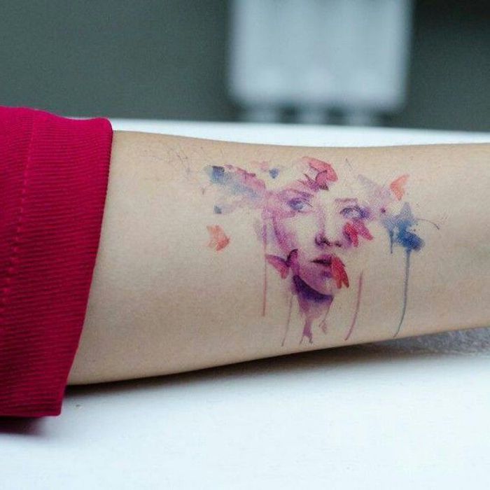 pink female face, surrounded by buterflies, forearm tattoo, watercolor tattoo fade, red sleeve