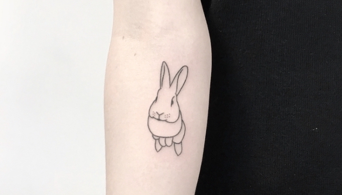 best place to get a tattoo, hopping bunny, forearm tattoo, black top, white background