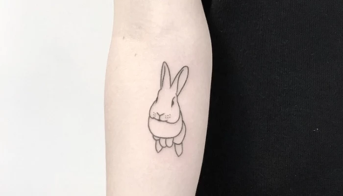 best place to get a tattoo, hopping bunny, forearm tattoo, black top, white background