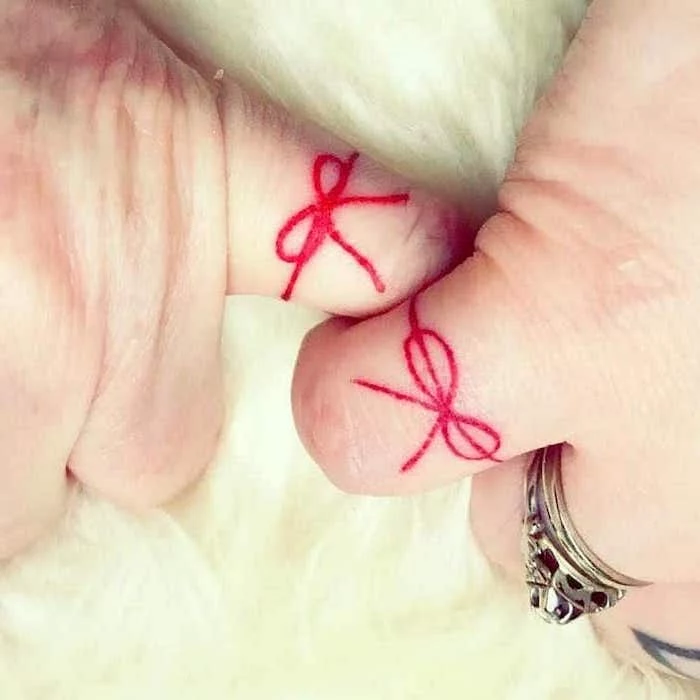 red bow, finger tattoos, mother daughter tattoos on wrist, vintage ring
