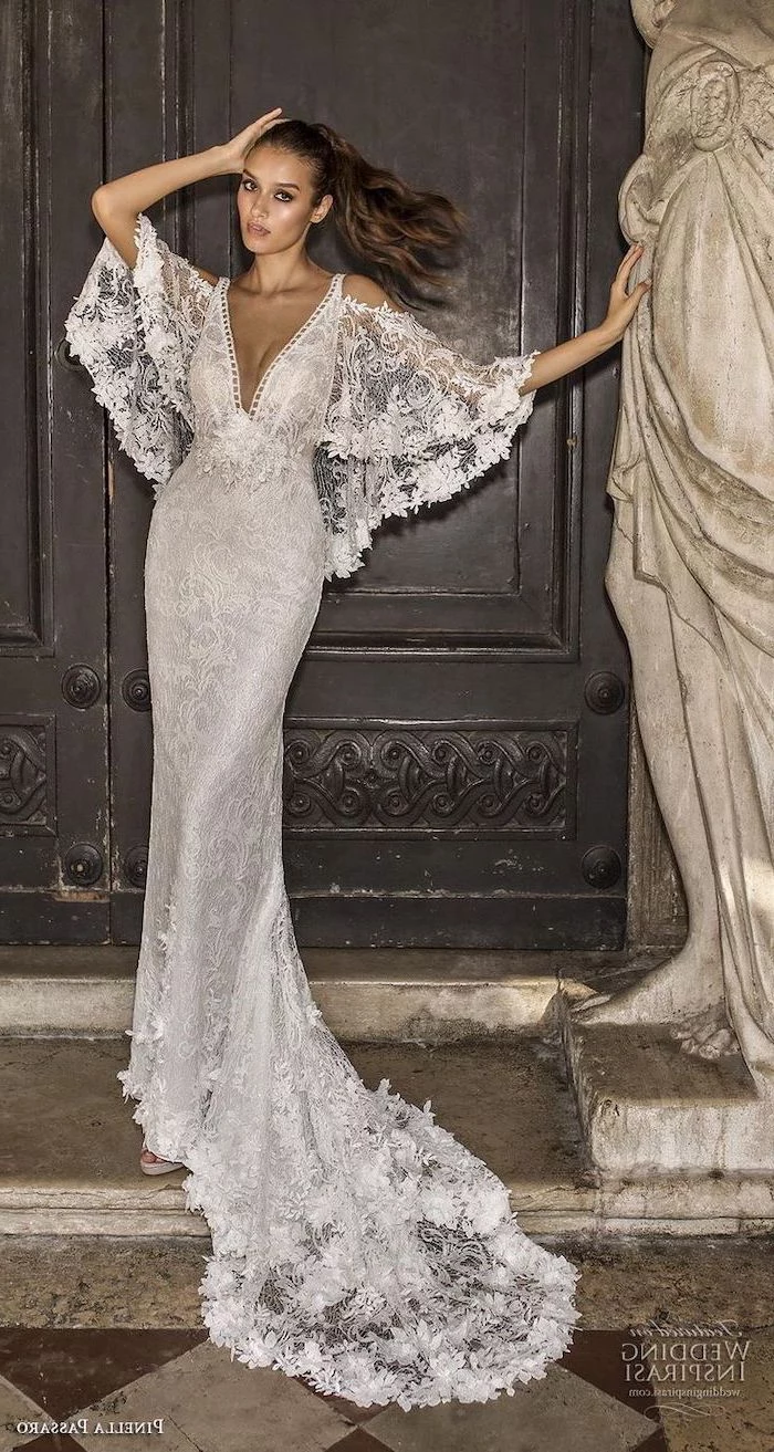 wide sleeves, lace dress, short sleeve wedding dress, black metal door, brown hair, in a ponytail
