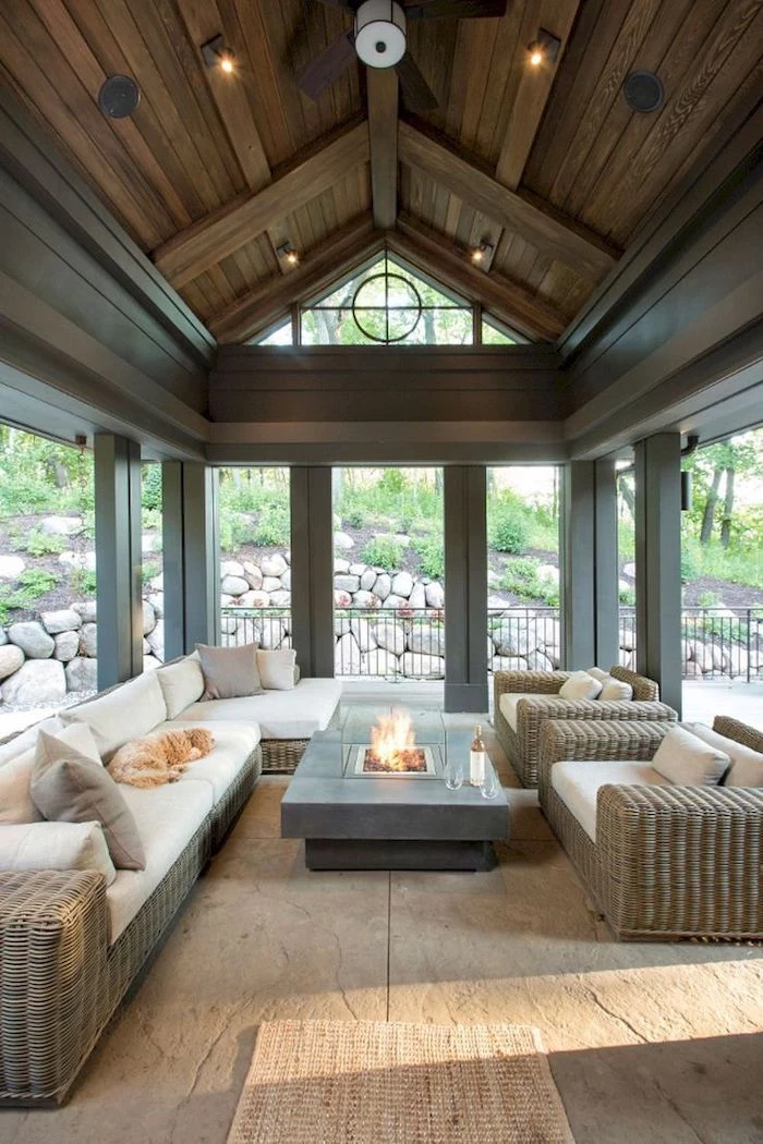a shaped ceiling, garden furniture, white cushions, small electric fireplace, screened in porch furniture