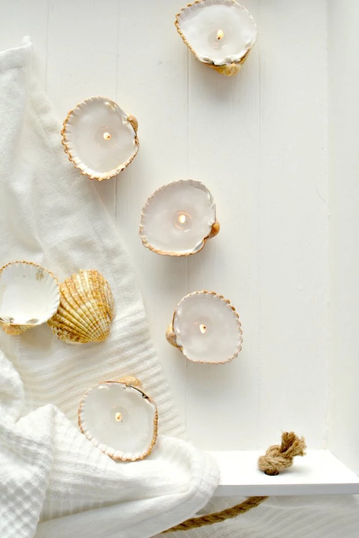 candle holders, made of seashells, cute diys, white towel, wooden shelf