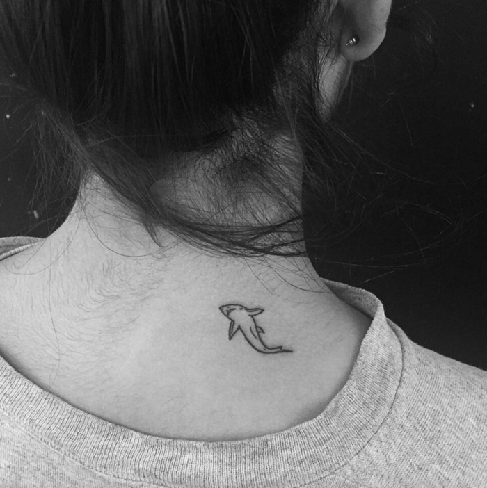 dolphin back tattoo, black and white photo, grey blouse, best place to get a tattoo