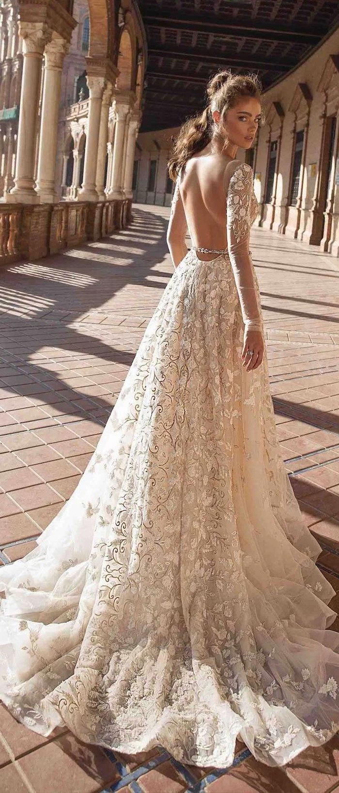 long sleeve lace mermaid wedding dress, bare back, long train, brown hair, in a ponytail