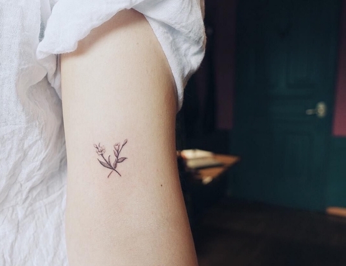 hidden tattoos, flowers inside arm tattoo, white shirt, blue door