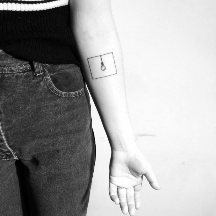 light bulb, inside a square, forearm tattoo, hidden tattoos, black and white photo, black jeans