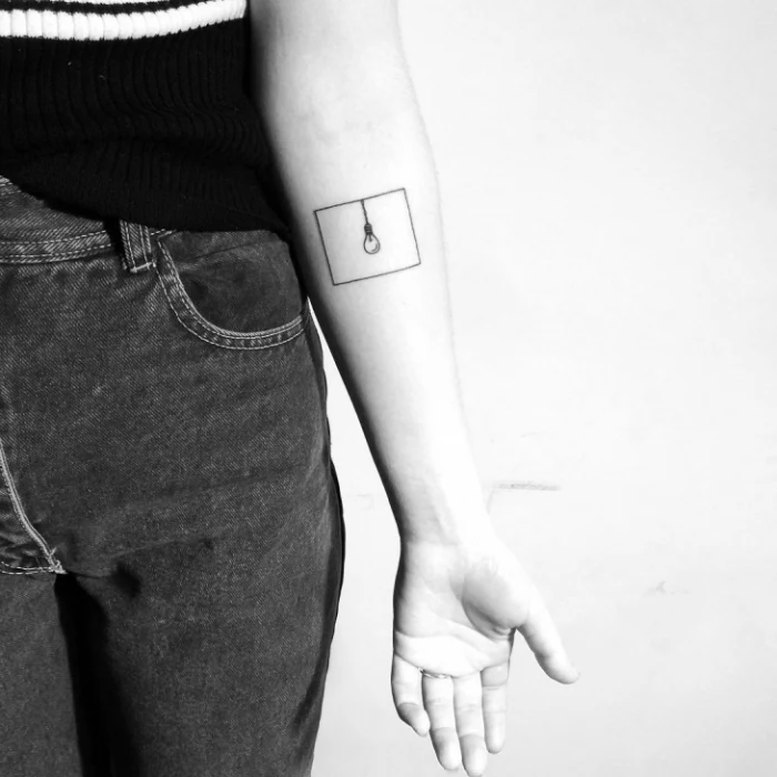 light bulb, inside a square, forearm tattoo, hidden tattoos, black and white photo, black jeans