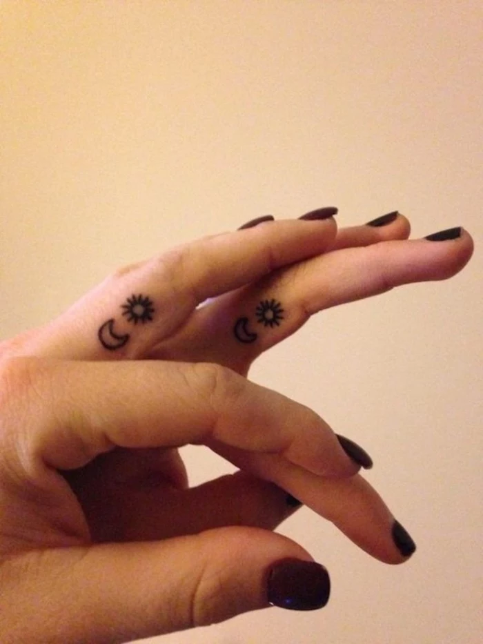 cute matching tattoos, black nail polish, sun and moon, finger tattoos, white background