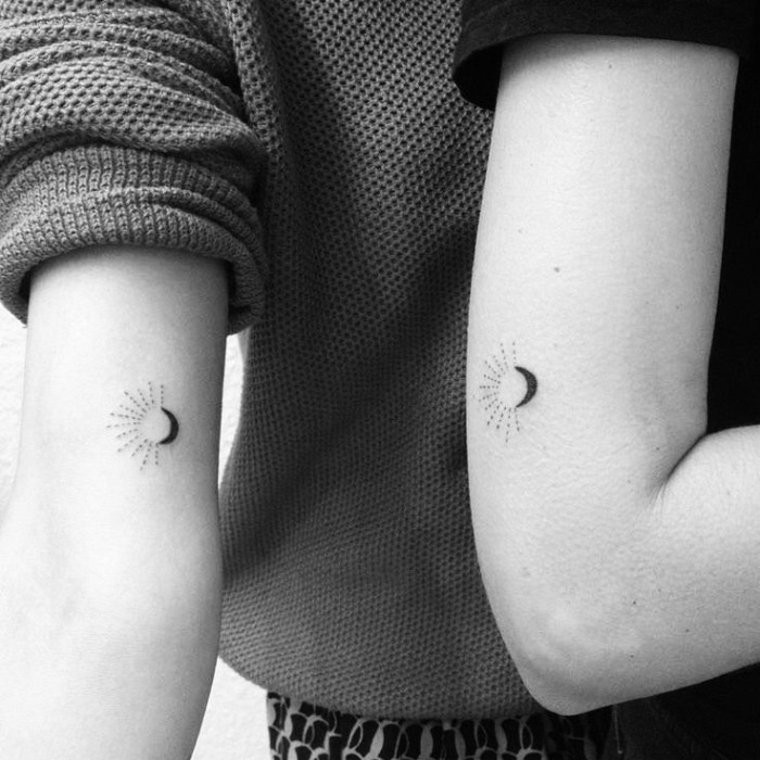 black and white photo, cute matching tattoos, sun and moon, back of arm tattoos