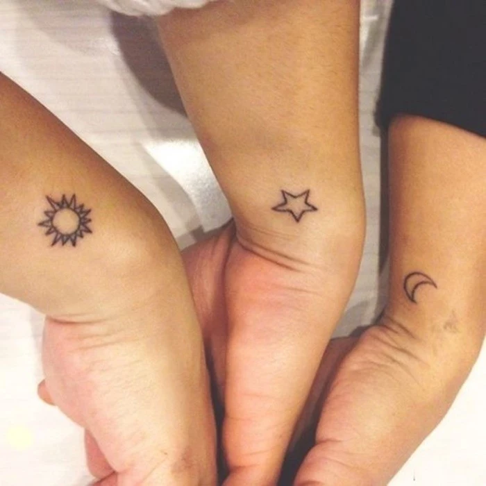 sun stars and moon, cute matching tattoos, wrist tattoos, white background, side by side arms
