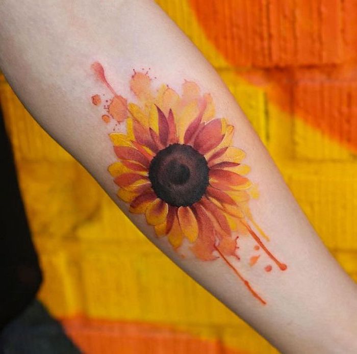 sunflower forearm tattoo, delicate female tattoos, orange and yellow background
