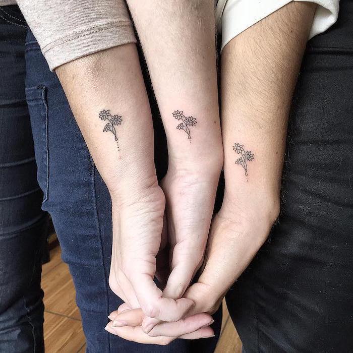 three flowers, three hands, daughter tattoo ideas, side arm tattoos, holding hands