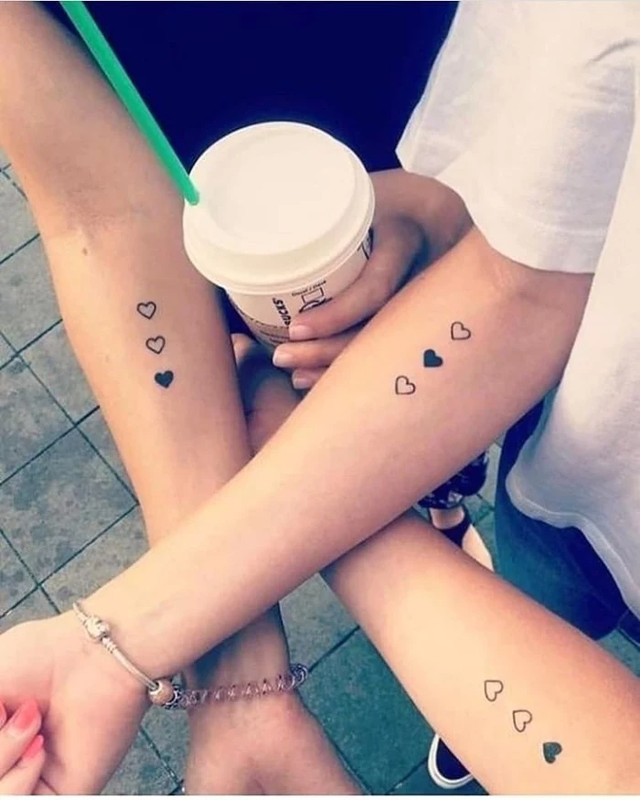 friendship tattoos designs, three hearts, hands intertwined, forearm tattoos, starbucks cup