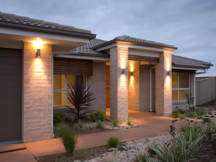 green bushes, in the gravel, brick columns, front porch furniture ideas, tiled pathway