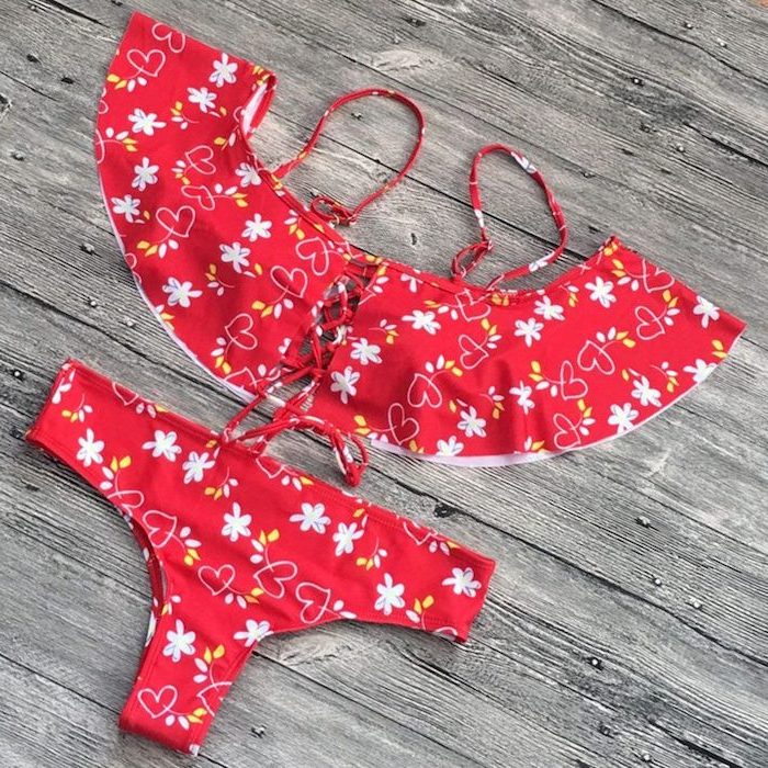 red with white flowers and hearts print, two piece, cute swimsuits for girls, wooden background