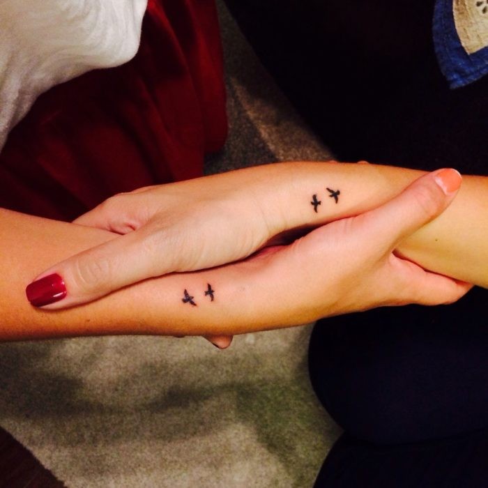 red n ail polish, friendship tattoos designs, two birds flying, side arm tattoos