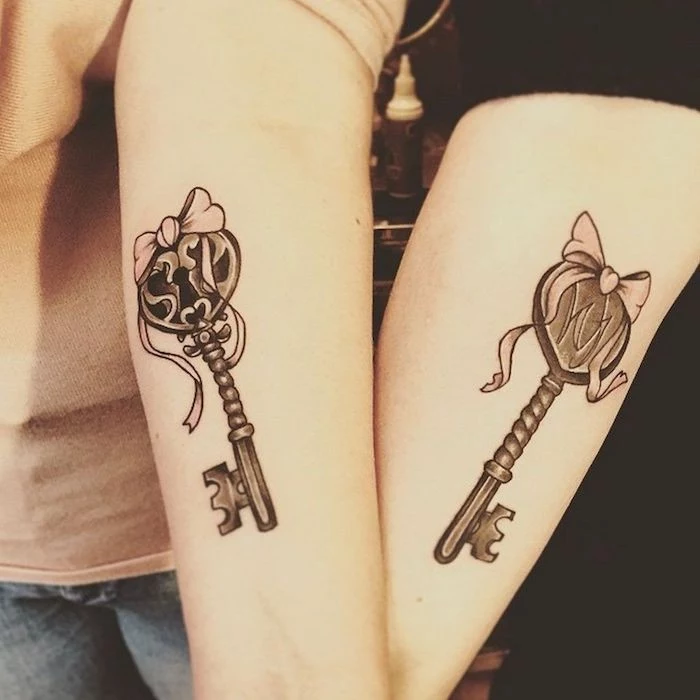 two keys, with bows, matching bestfriend tattoos, forearm tattoos, grey and black blouses