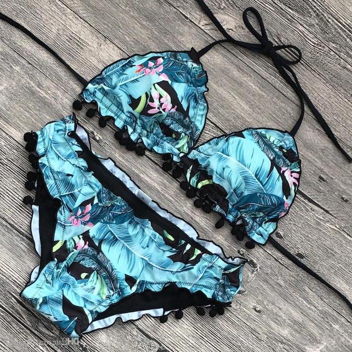 blue palm leaves print, two piece, cute swimsuits for girls, black straps, wooden background