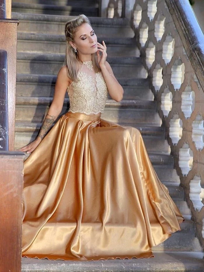 lace top, gold satin skirt, sparkly bridesmaid dresses, blonde hair, woman sitting on a staircase