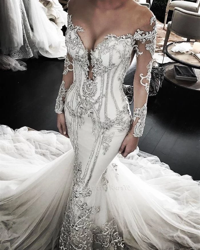 white dress, silver beads, white tulle train, black wooden floor, off shoulder, v neckline, gowns with sleeves