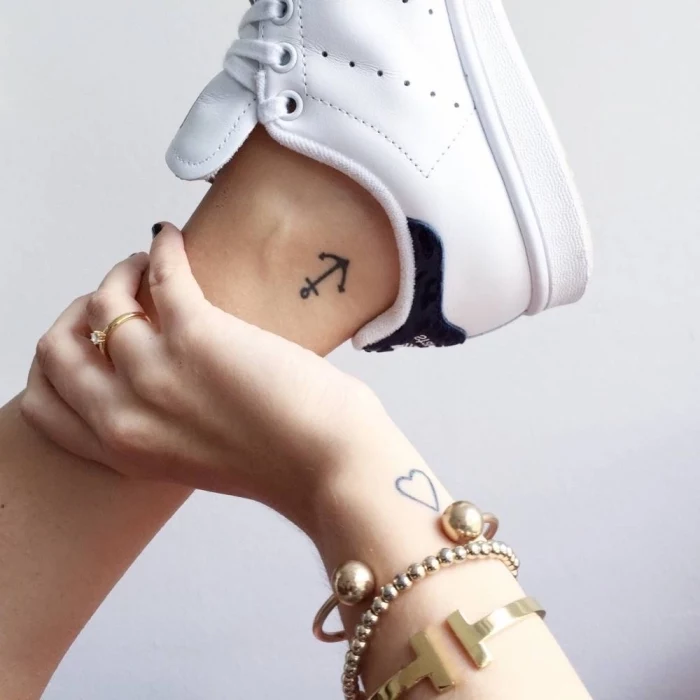 anchor ankle tattoo, heart wrist tattoo, white sneakers, gold bracelets, subtle tattoos