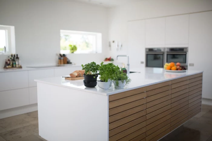 wooden kitchen island, white countertops, planted herbs, fruit bowl, remodeling a kitchen