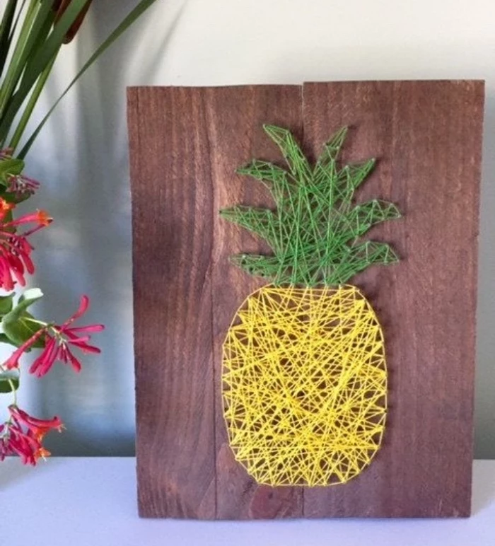 wooden background, pineapple made of yarn, things to do when bored for kids