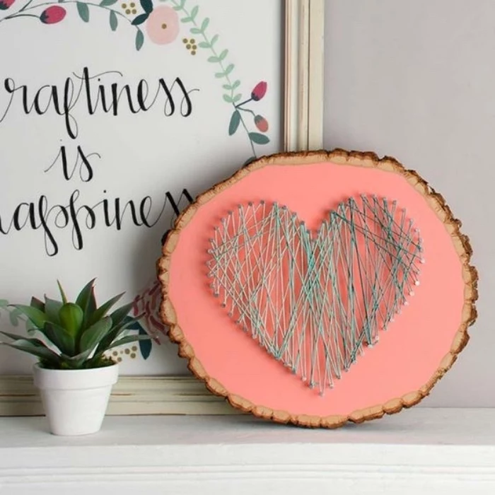 wooden board, pink background, heart made of yarn, diy crafts for adults, potted flower