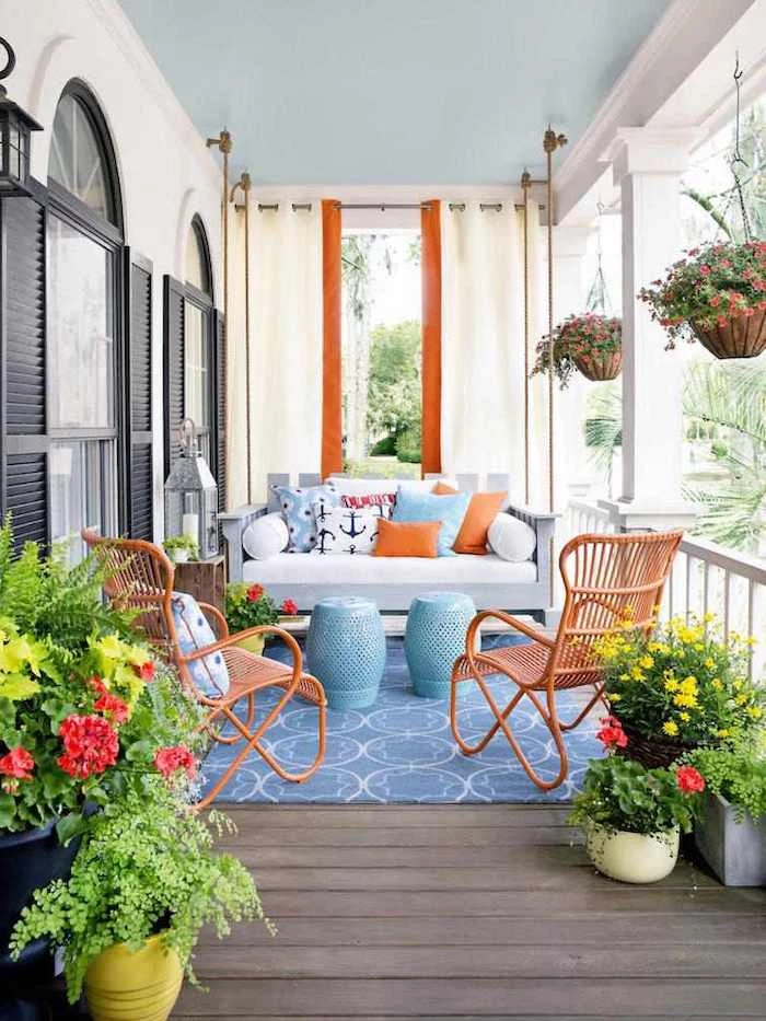 wooden swing, wooden chairs, white cushions, blue and orange throw pillows, front porch pictures
