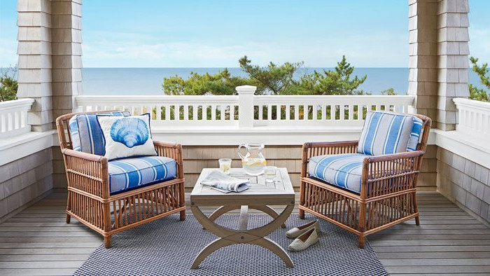 wooden chairs, grey and blue throw pillows, grey rug, screened in porch ideas, ocean view