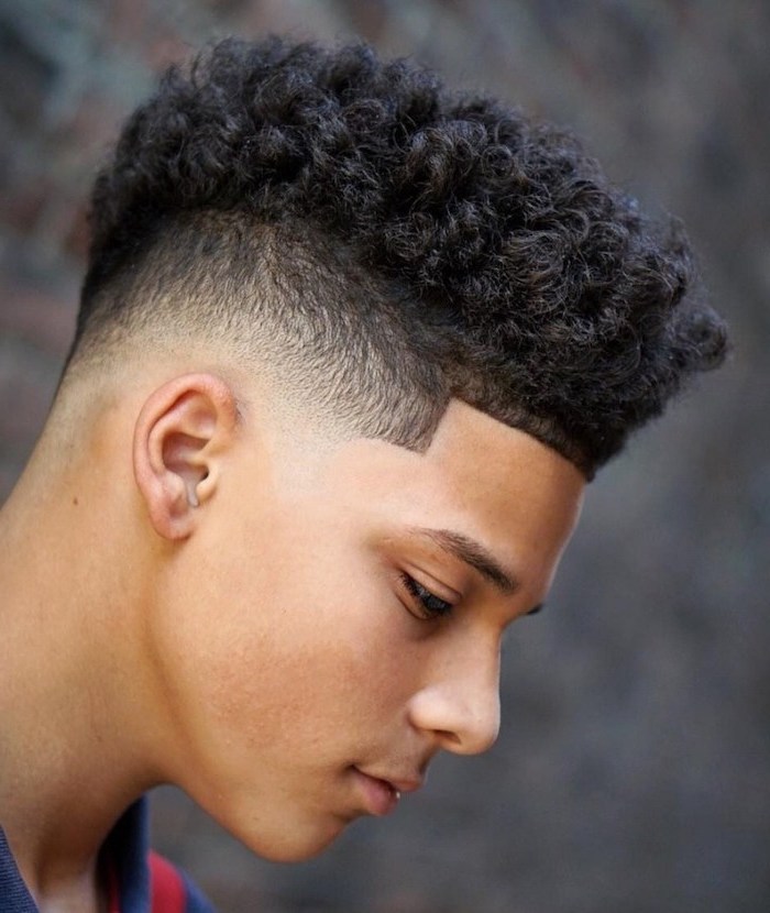 short black curly hair, short guy haircuts, blurred background