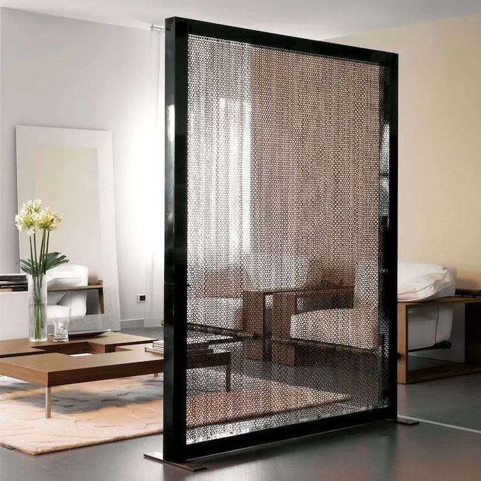 black frame, hanging chainmail, black floor, white armchairs, wooden table, white carpet, room dividers