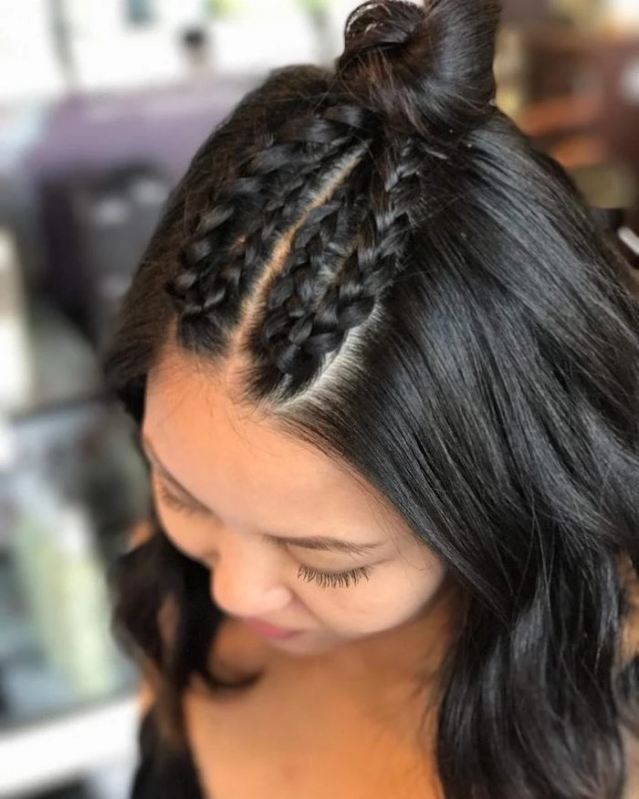 black hair, four small braids, small bun, how to do a french braid, blurred background
