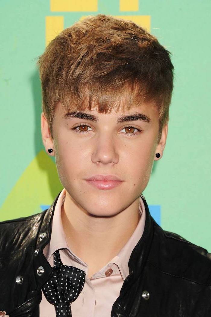 black earrings, cool haircuts for men, justin bieber, black leather jacket, brown hair, green background