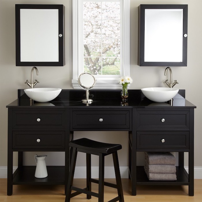 black table, two sinks, two mirrors, black metal stool, small round mirror, makeup vanity with lights