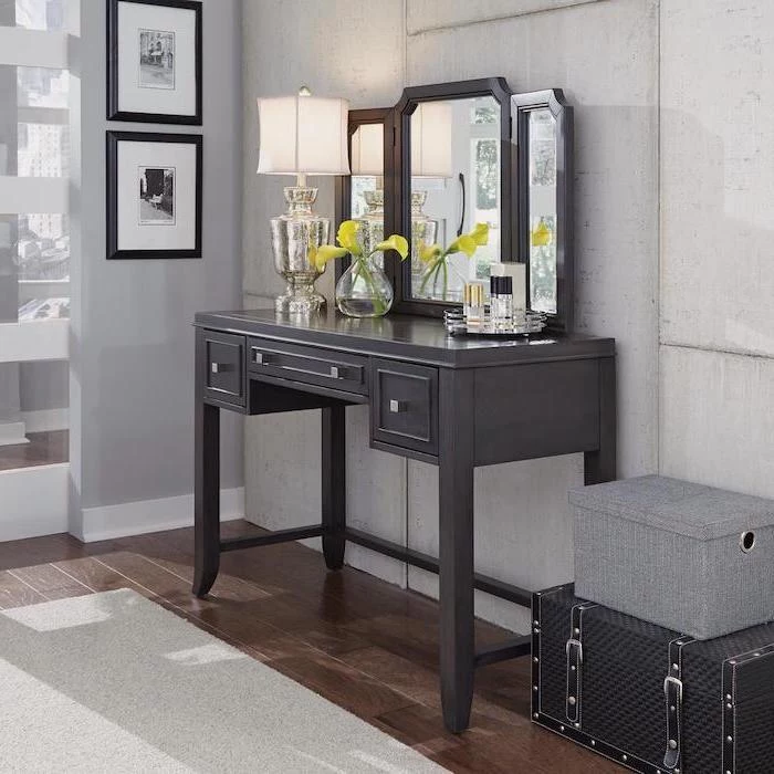 three fold mirror, black makeup vanity, wooden floor, white carpet, white walls