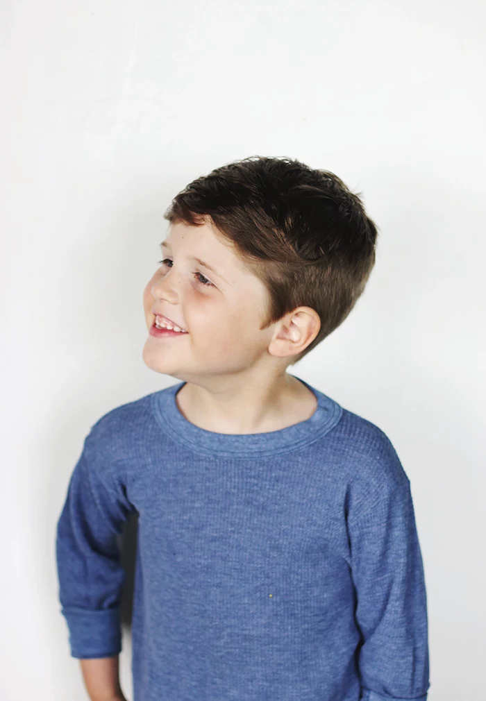 white background, cute boy haircuts, blue blouse, brown hair, little boy