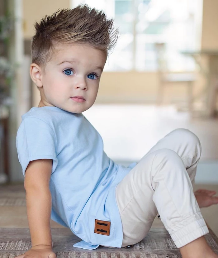 little boy, with blonde hair, blue eyes, blue shirt, white pants, guy hairstyles