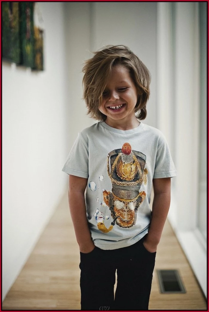 toddler boy haircut, boy smiling, blonde hair, medium length, white shirt, black pants