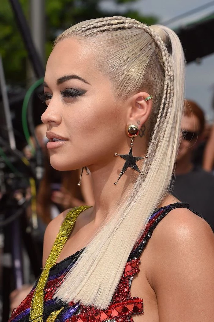 rita ora, with blonde hair, small braids, in a ponytail, box braids hairstyles, sequinned colourful dress