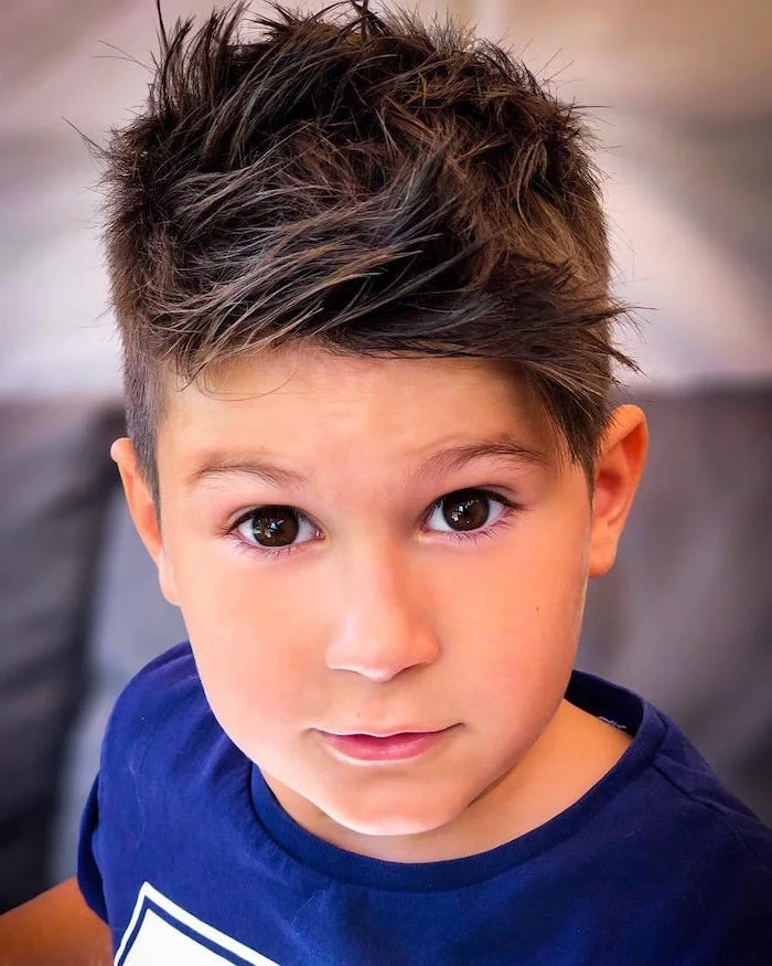 little boy, with brown eyes, brown hair, toddler boy haircut, blue shirt