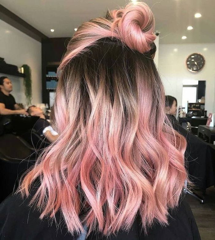 brown to rose gold, pink hair in a bun, medium length, wavy hairstyle, blonde ombre hair