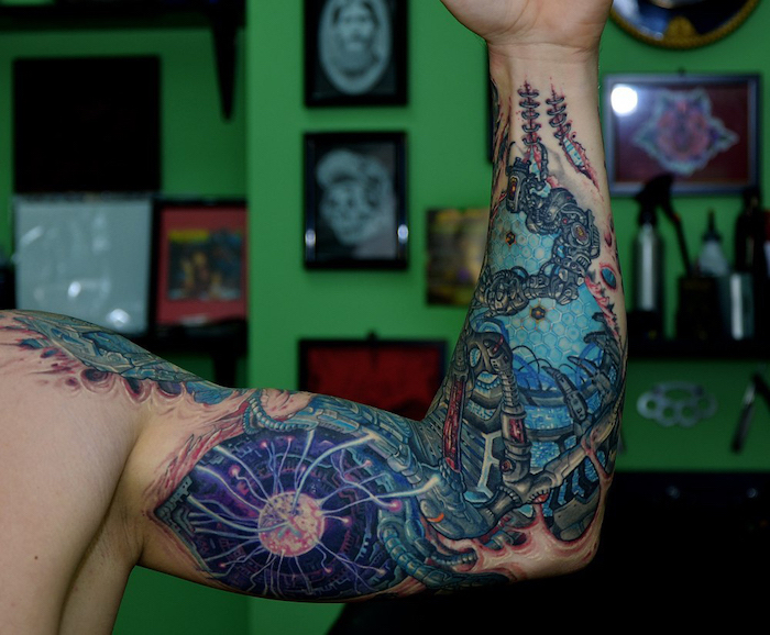 coloured biomechanical, arm tattoo ideas, green background, photo frames